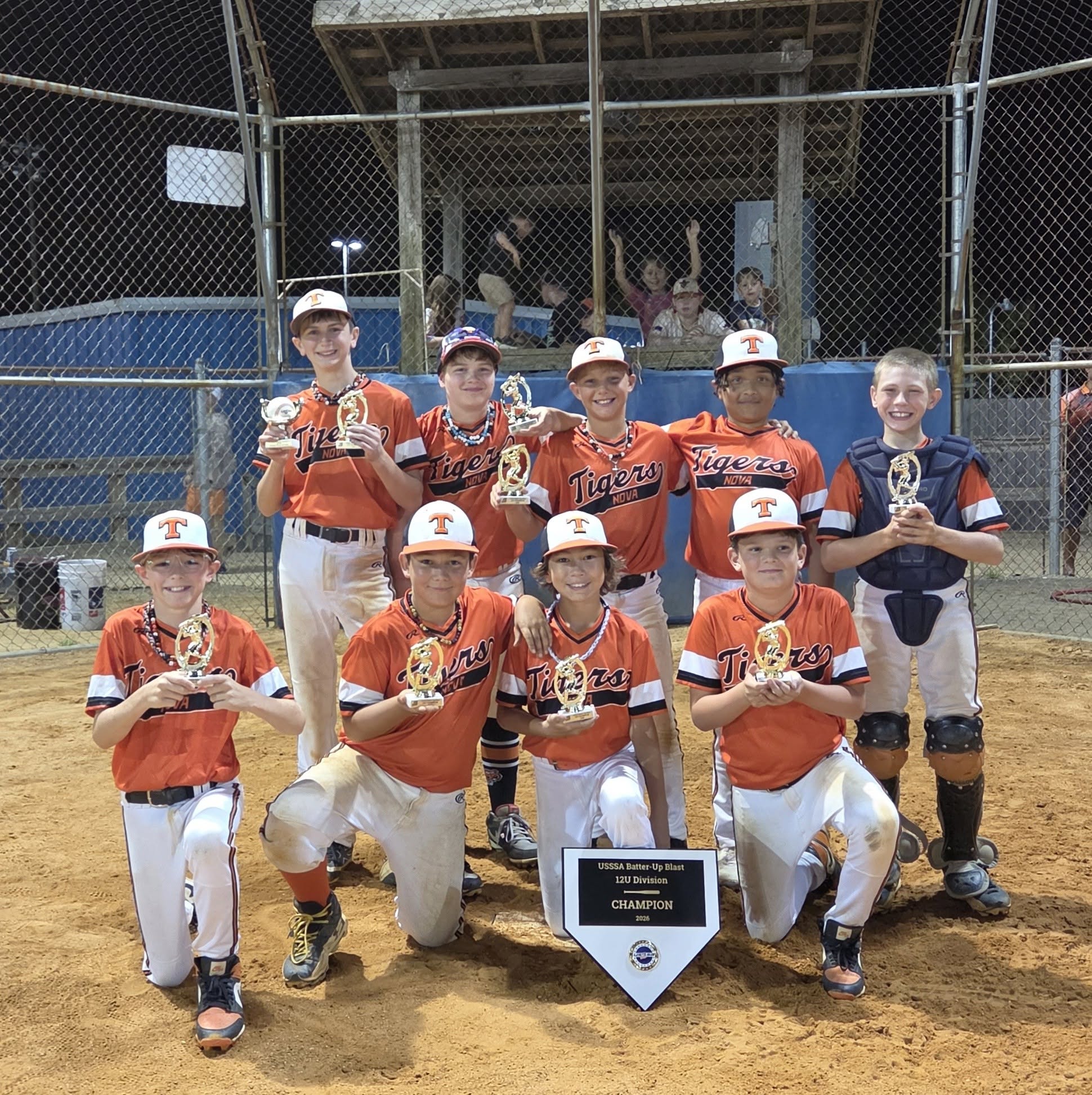 Rawlings Tigers NOVA 12U players holding trophies with their 2026 USSSA Batter-Up Blast 12U Division champion banner